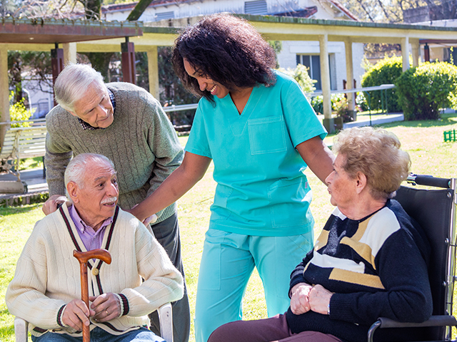 Nurse assisting elderly patients at an assisted living facility